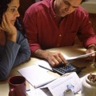 5 Financial Stats You Need to Know to be Successful with Money Woman and man working on calculator