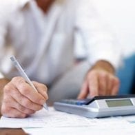 Now Frugal Man Needs a Budget as Retirement Approaches Man figuring budget on a calculator