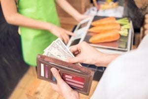 Man buying with cash instead of a credit card