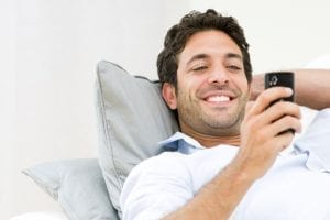 Happy man with a new cellphone.