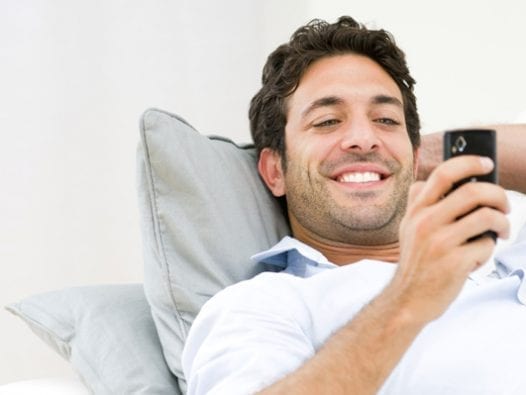Stuck With Bad Credit Score? T-Mobile Offers Some Relief Happy man with a new cellphone.