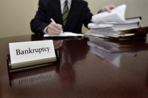 Man Filing Papers For Bankruptcy