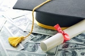 Graduation cap on stack of money