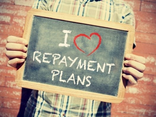 Student Loan Repayment A Benefit Millennials Love Millennial holding a sign that declares their love for loan repayment plan