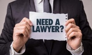 Lawyer with sign that asks if you need a lawyer