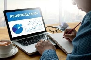 How to get a Personal Loan - Man on a computer applying for loan