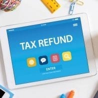Practical Suggestion for Tax Refund: Pay off Credit Card Debt! Tablet Screen with Tax Refund displayed on it