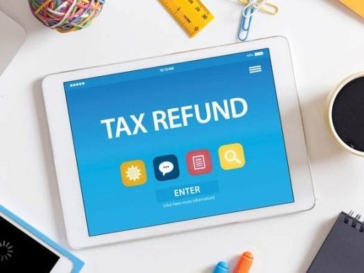 Practical Suggestion for Tax Refund: Pay off Credit Card Debt! Tablet Screen with Tax Refund displayed on it