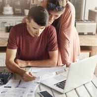 How to Pay off Holiday Debt Fast: 5 Strategies Woman and man stressing over holiday bills