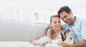 Happy Couple in home with dog
