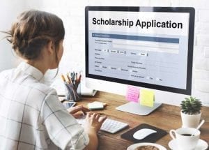 Women applying for College Scholarship and Grants on computer
