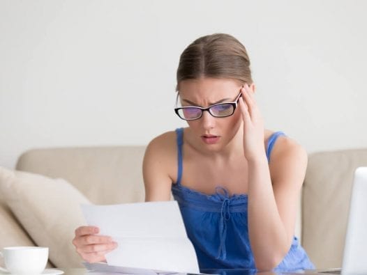 Debt Consolidation or Bankruptcy? Which is Better? woman stressed about bills