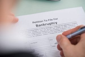 Man filling out form for bankruptcy