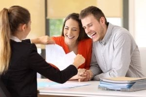 Happy couple getting debt relief from counselor