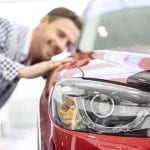 Young male student who is looking at a car to buy with a student loan
