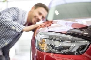Young male student who is looking at a car to buy with a student loan