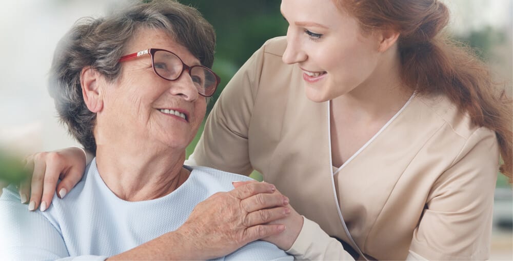 Happy Nurse and Elderly Women in Assisted Living or Nursing Home