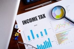 Filing income taxes with papers and charts