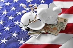 Piggy bank and money on American flag