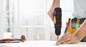 Man working to improve his house with a cordless drill