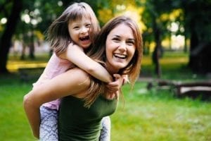 Woman carrying child with special needs