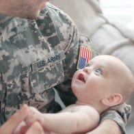 NFCC Survey Shows Military Families Financial Struggles Military father holding his new born baby