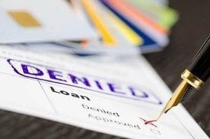Debt consolidation loan application with denied stamped on it