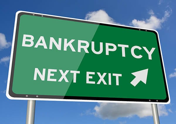 Highway exit sign with arrow to bankruptcy