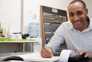 Businessman doing finances in his own small business