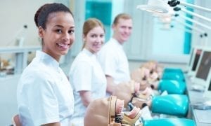 Three young happy future dentistry doctors in class at dental school