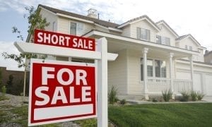 Picture of for sale short sale sign in front of two story house