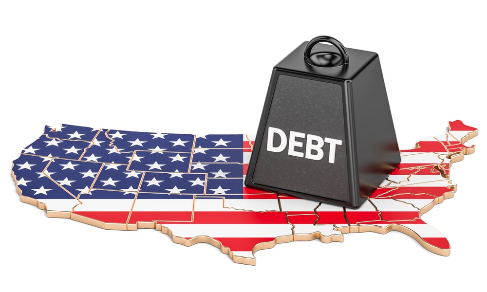 3D Render of puzzle like U.S model with weight on top labeled "DEBT"