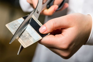 Cutting a credit card with scissors