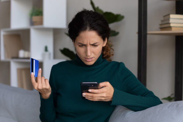 Woman confused why her credit card was denied while shopping on her phone