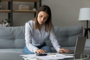 Woman researching balance transfers and personal loans on a computer