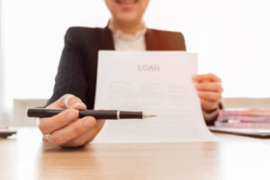 Banker holding loan contract pointing out the loan origination fee