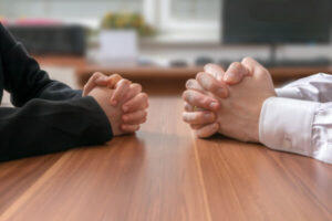 Two individuals negotiating at a table