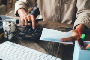 Man calculating a tax payment after debt settlement