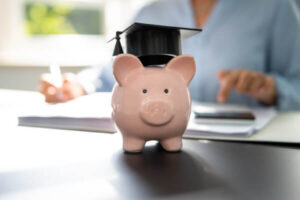 Piggy bank with graduation cap on