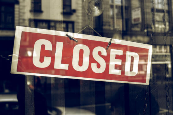 Closed sign on front door of business