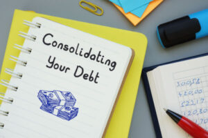 Notepad labeled Consolidating Your Debt