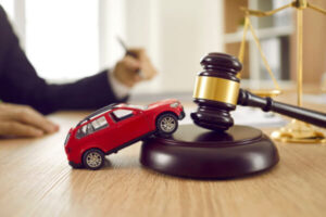 A toy car next to a judge's gavel