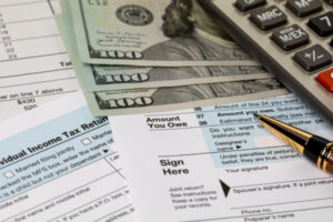 IRS tax documents next to money on desk